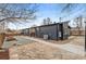 Updated exterior with modern design featuring stone pavers, gravel yard, and convenient walkway along side of home at 5523 Tejon St, Denver, CO 80221