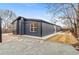 Modern exterior with a dark painted design complemented by a well-manicured gravel and stone yard and natural landscaping at 5523 Tejon St, Denver, CO 80221