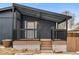 Covered porch with wood decking provides a cozy entrance to the home at 5523 Tejon St, Denver, CO 80221