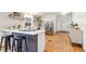 Modern kitchen with stainless steel appliances, floating shelves and a breakfast bar at 5523 Tejon St, Denver, CO 80221