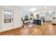 Open concept kitchen with island seating, stainless steel appliances, and hardwood flooring at 5523 Tejon St, Denver, CO 80221