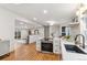 Open concept kitchen flows into the living area, featuring hardwood floors at 5523 Tejon St, Denver, CO 80221