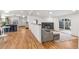 Open-concept living room flowing from the kitchen with hardwood floors and a fireplace at 5523 Tejon St, Denver, CO 80221