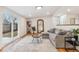Bright living room with a large sectional sofa, backyard view, and hardwood flooring at 5523 Tejon St, Denver, CO 80221