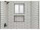 Modern shower adorned with white subway tile, black trim, niche, and black fixtures at 5523 Tejon St, Denver, CO 80221