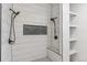 Updated shower featuring dual shower heads, a convenient bench, eye-catching tile and a shower product nook at 5523 Tejon St, Denver, CO 80221