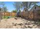 Home's backyard includes a wood fence, and mature trees that provide shade for a potential garden at 1529 E 22Nd Ave, Denver, CO 80205