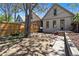 Home's backyard includes a stone seating area, wooden retaining wall and mature shade trees at 1529 E 22Nd Ave, Denver, CO 80205