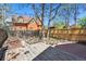 Backyard features a wood deck, brick patio and a wood fence with mature shade trees at 1529 E 22Nd Ave, Denver, CO 80205