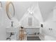 Cozy bathroom with a standalone tub, modern sink, round mirror and natural light from a window at 1529 E 22Nd Ave, Denver, CO 80205