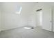 Bedroom featuring all white decor, a skylight, and an open door at 1529 E 22Nd Ave, Denver, CO 80205