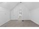 Bright bedroom with neutral carpeting, white walls, and a view into another room at 1529 E 22Nd Ave, Denver, CO 80205