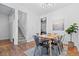 Dining room with modern table set, original hardwood floors, and access to the staircase at 1529 E 22Nd Ave, Denver, CO 80205