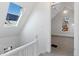Bright hallway features a skylight with solar panels, and leads to a carpeted room with natural light at 1529 E 22Nd Ave, Denver, CO 80205
