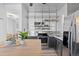 Bright kitchen featuring stainless steel appliances, custom shelving, and a stylish butcher block island at 1529 E 22Nd Ave, Denver, CO 80205