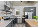 Modern kitchen with stainless steel appliances, floating shelves, and stylish gray cabinets at 1529 E 22Nd Ave, Denver, CO 80205