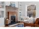 Cozy living room with a fireplace, built-in shelves and abundant natural light at 1529 E 22Nd Ave, Denver, CO 80205