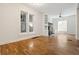 Spacious living room featuring gleaming hardwood floors, built in shelving and large windows at 1529 E 22Nd Ave, Denver, CO 80205