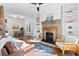 Bright living room with fireplace, built-in shelving, and hardwood floors at 1529 E 22Nd Ave, Denver, CO 80205