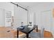Stylish office features a modern chair, desk, and barn door, and hardwood floors at 1529 E 22Nd Ave, Denver, CO 80205