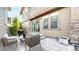 Cozy back patio featuring stone pavers, outdoor seating, grill, and sliding glass door to the home's interior at 7932 E 49Th Pl, Denver, CO 80238