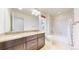 Bathroom offers dual sinks, granite counters, shower-tub combo, and good lighting at 7932 E 49Th Pl, Denver, CO 80238