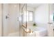 Bathroom showcasing a separate glass shower, soaking tub, and tiled surrounds at 7932 E 49Th Pl, Denver, CO 80238