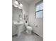 Powder room with pedestal sink, decorative art, and tiled floors at 7932 E 49Th Pl, Denver, CO 80238