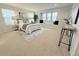 Bright primary bedroom features a window seat, neutral decor, and a cozy rug at 7932 E 49Th Pl, Denver, CO 80238