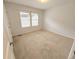 Carpeted bedroom with neutral walls, two windows with mini blinds, and a closet at 7932 E 49Th Pl, Denver, CO 80238