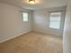 Carpeted bedroom with neutral walls, two windows with mini blinds, and a closet at 7932 E 49Th Pl, Denver, CO 80238