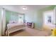 Carpeted bedroom with light green walls, white furniture and trim, with natural light at 7932 E 49Th Pl, Denver, CO 80238