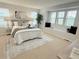 Bright primary bedroom features a window seat, neutral decor, and a cozy rug at 7932 E 49Th Pl, Denver, CO 80238