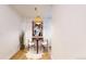 Cozy dining area features light floors, modern artwork, and a unique pendant light fixture at 7932 E 49Th Pl, Denver, CO 80238