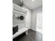 Mud room area with built-in bench, hooks, a shelf, and dark wood floors at 7932 E 49Th Pl, Denver, CO 80238