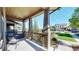 Inviting front porch with cozy seating, offering a relaxing outdoor space in a charming neighborhood at 7932 E 49Th Pl, Denver, CO 80238