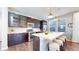 Modern kitchen featuring an island with seating and stainless steel appliances at 7932 E 49Th Pl, Denver, CO 80238