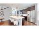 Stylish kitchen with stainless appliances, a large island, and modern pendant lighting at 7932 E 49Th Pl, Denver, CO 80238