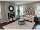 Stylish living room features a fireplace, comfortable sofa, accent seating, and a large area rug at 7932 E 49Th Pl, Denver, CO 80238