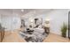 Bright living room features light hardwood floors, comfortable seating, and modern decor at 7932 E 49Th Pl, Denver, CO 80238