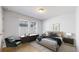 Comfortable bedroom featuring neutral colors and a cozy sitting area at 7932 E 49Th Pl, Denver, CO 80238