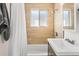 Bathroom features a shower over tub combination, vanity, and wood look tile at 3251 N Adams St, Denver, CO 80205