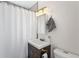 Bathroom features a vanity, mirror, shower curtain and commode at 3251 N Adams St, Denver, CO 80205