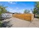 Long driveway with wooden fence next to garage, providing privacy and parking at 3251 N Adams St, Denver, CO 80205
