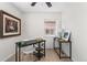 Bright home office featuring modern decor, a sleek black desk, and natural light from a window at 3251 N Adams St, Denver, CO 80205
