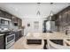 Modern kitchen with stainless steel appliances, granite countertops, and breakfast bar at 3251 N Adams St, Denver, CO 80205