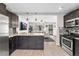 Modern kitchen with granite countertops, stainless appliances open to a spacious living room at 3251 N Adams St, Denver, CO 80205