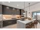 Stylish kitchen with stainless steel appliances, island with seating, and modern pendant lighting at 1901 Wazee St # 707, Denver, CO 80202