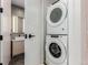 Laundry nook featuring a stacked washer and dryer, and a view to a bathroom at 1901 Wazee St # 707, Denver, CO 80202