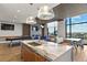 Open-concept space with a modern kitchen island, a fireplace, city view, and ample seating at 1901 Wazee St # 707, Denver, CO 80202